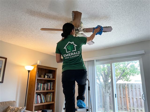Emerald Pro cleaner dusting a ceiling fan